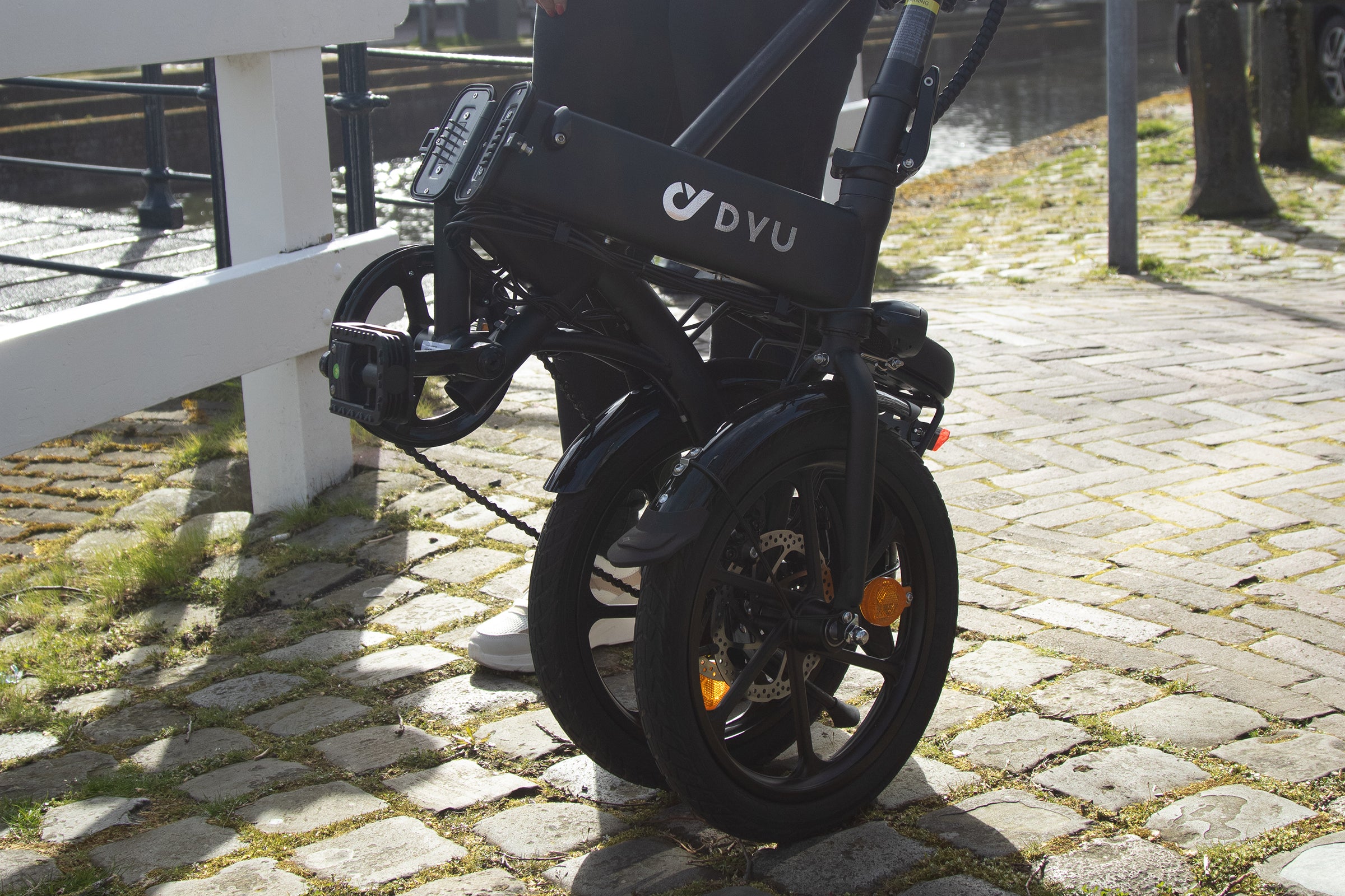 DYU C6 electric bike, compact and handy for urban transport, parked on cobblestones. DYU C6 electric bike, compact and handy for urban transport, parked on cobblestones.