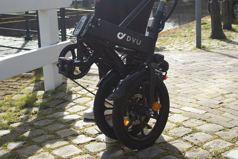 DYU C6 electric bike, compact and handy for urban transport, parked on cobblestones. DYU C6 electric bike, compact and handy for urban transport, parked on cobblestones.