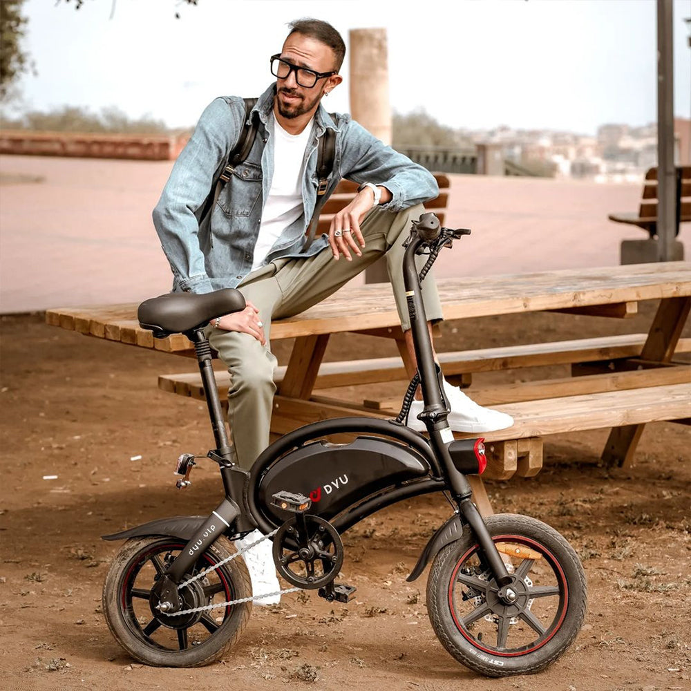 Elisabeth Dutranois is riding an electric bicycle on a dirt road