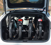 DYU C2 16 Inch Full Folding Electric Bike folded and placed in a car trunk.