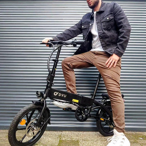 Rider on DYU A1F black folding electric bike showcasing stylish design and front basket. Rider on DYU A1F black folding electric bike showcasing stylish design and front basket.