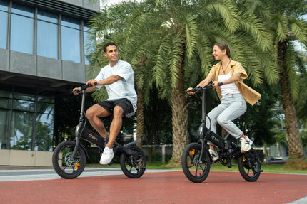 Two people riding electric bikes near palm trees.