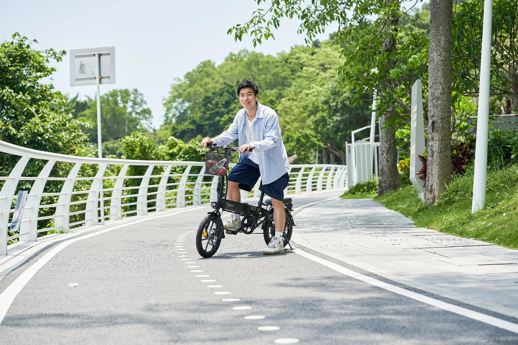 DYU A1F folding e-bike riding through a park bike lane in the UK