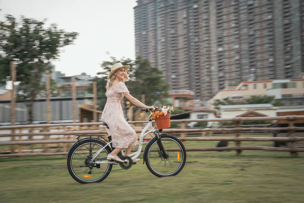 DYU C6 city e-bike riding through an urban UK-style setting