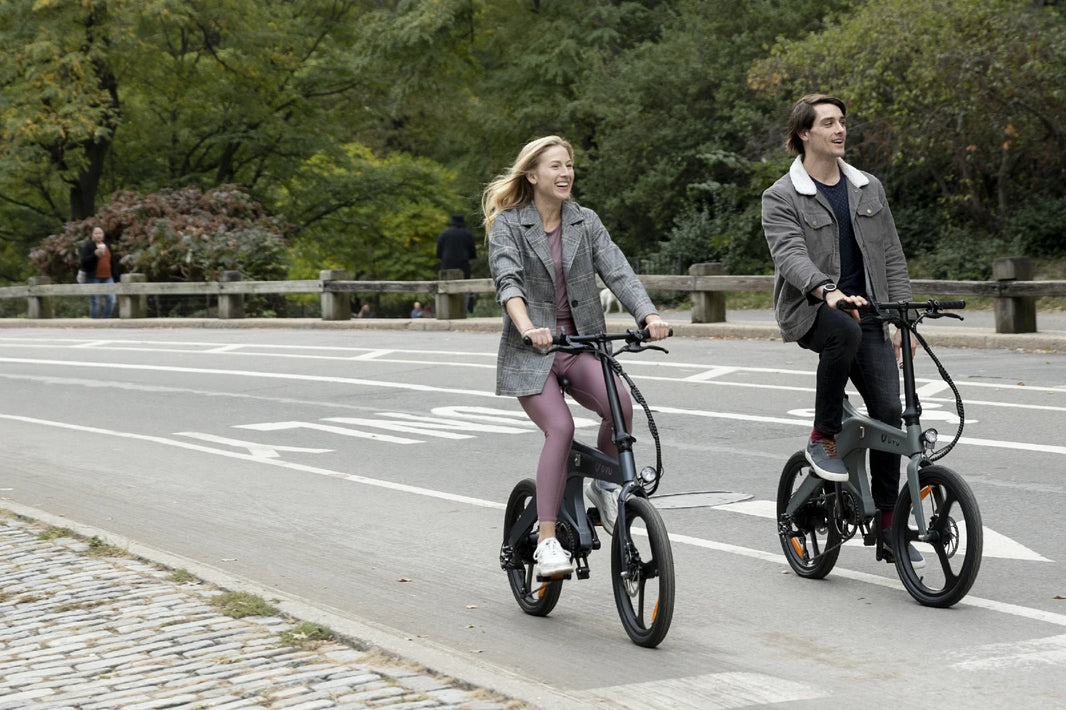 DYU T1 folding e-bike on a UK-style road for rain commute planning