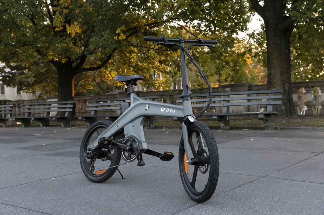 DYU T1 folding e-bike parked among park trees