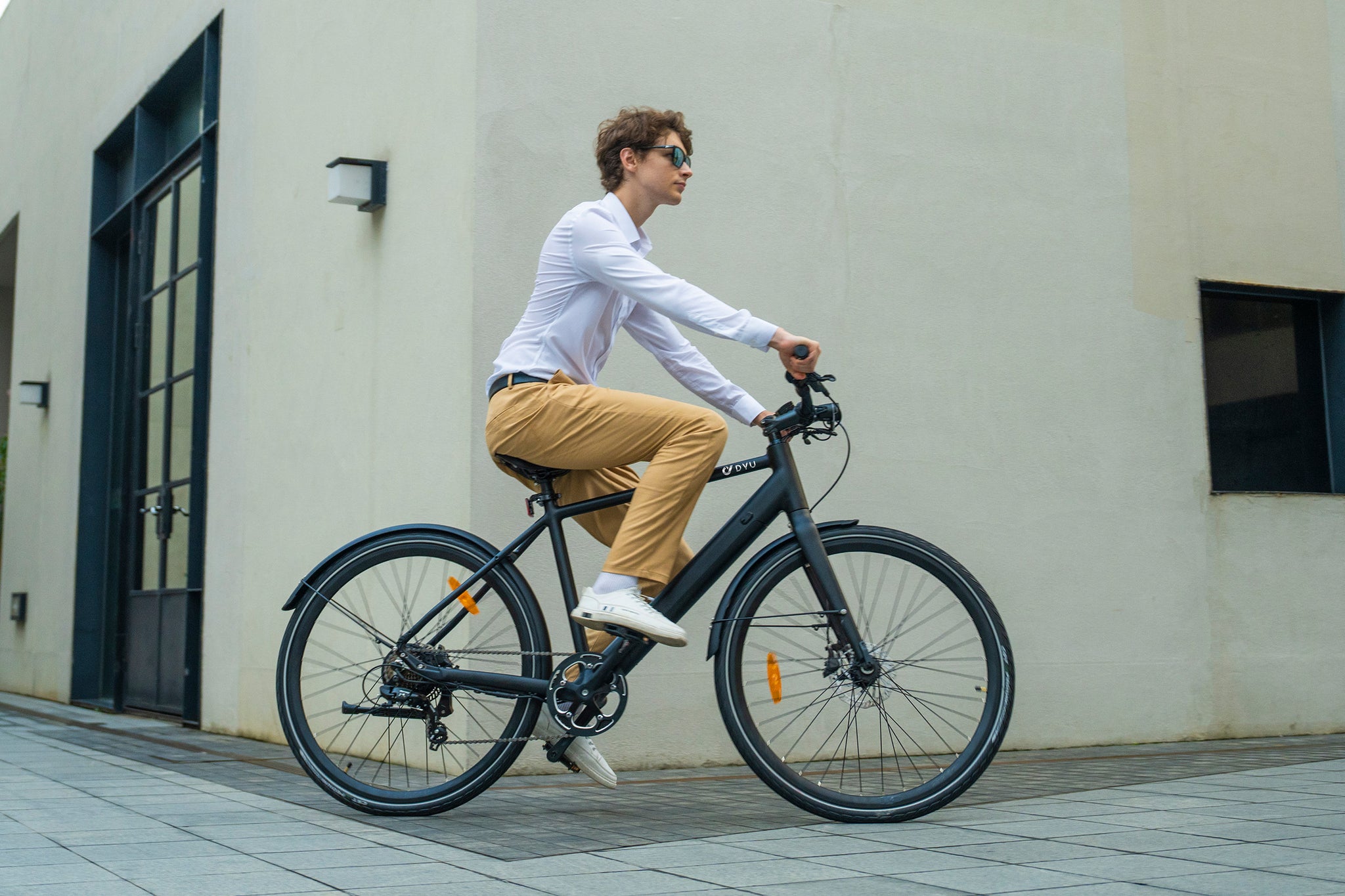 Man riding a black DYU Stroll 1 electric bike with stylish minimalist design.