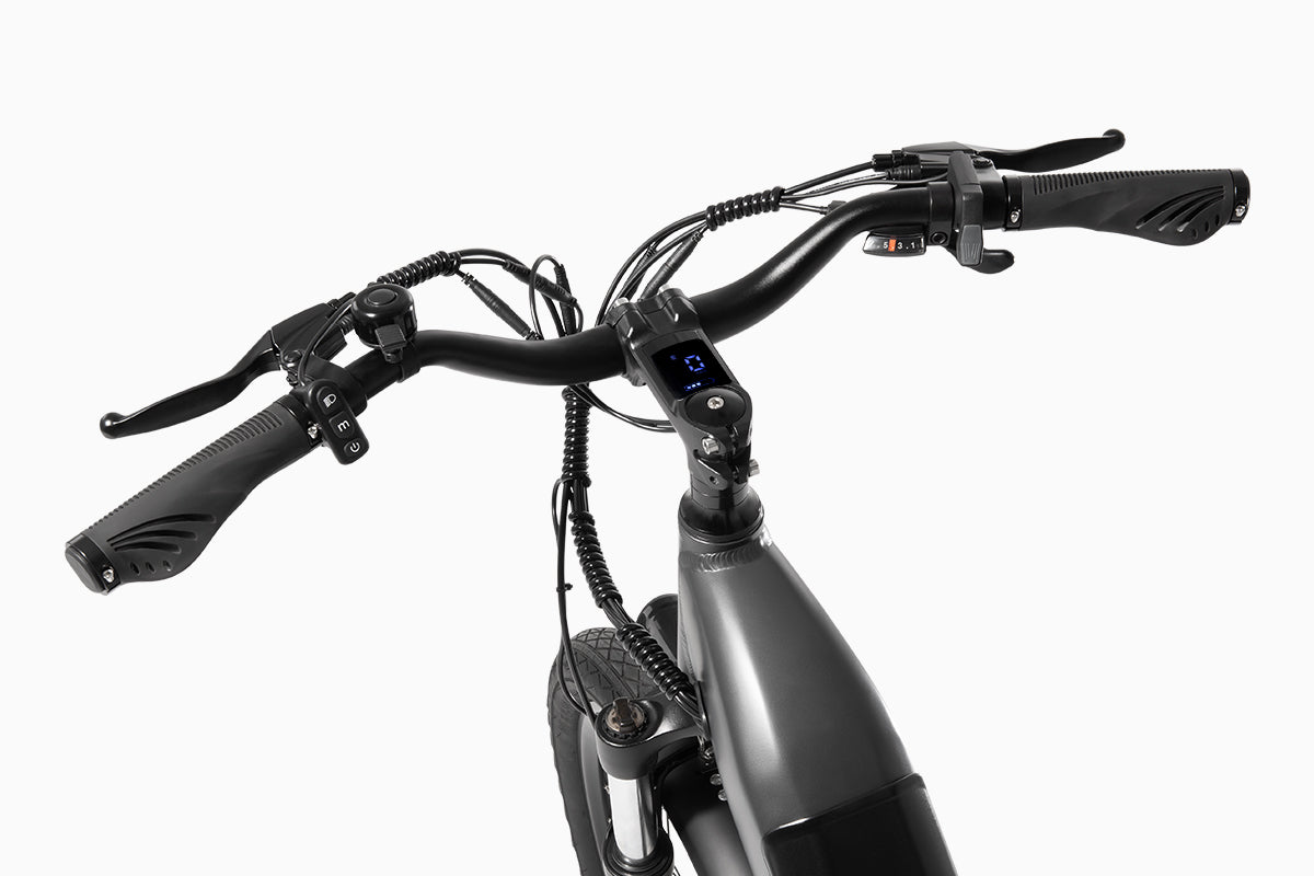 Close-up of DYU C1 electric bike handlebars featuring a digital display and brake levers.